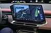 BMW-Cockpit mit großem Zentraldisplay, das Navigation und die Darstellung eines Fahrerassistenzsystems mit Fahrspuren und erkannten Fahrzeugen zeigt.