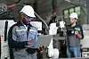 Male automation engineer checking and inspection control a robot arm welding machine with laptop computer in an industrial factory.Artificial intelligence concept.