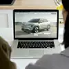 Couple exploring kia ev3 electric car website on laptop