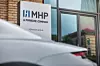 Logo am Eingang von MHP / Bis 2024: Porsche übernimmt MHP komplett