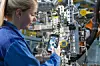 Eine Mitarbeiterin von BMW scannt einen QR-Code in der Produktion.